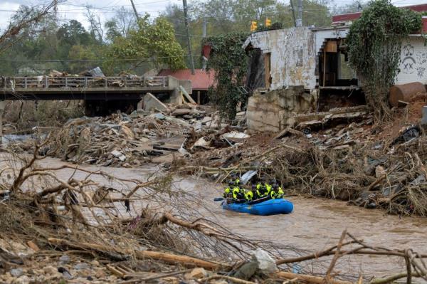 Rescuers paddling through a river in North Carolina, where the destruction from Helene was particularly strong